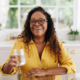 Senior woman drinking water at home.